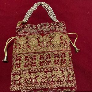 Brand new evening purse with gold embroidered work all around the purse